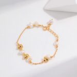 An elegant bracelet featuring  jewelry and freshwater pearls, displayed on a light background with a subtle shadow. Elegant pearl jewelry