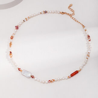 An elegant necklace featuring pearls and a mix of translucent and amber-toned gemstones, highlighted by rose gold accents, laid upon a white surface.