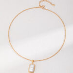 A delicate gold necklace with a natural pearl pendant, displayed on image0. Elegant pearl jewelry