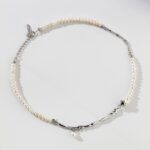 A delicatebracelet made of alternating sections of freshwater pearls and silver chain links, displayed on a white background with soft shadows. Elegant pearl jewelry