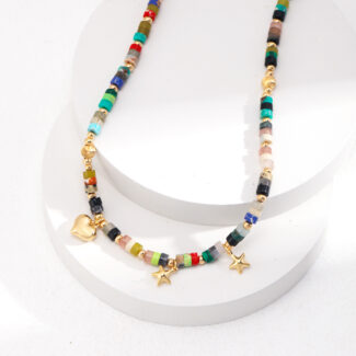 A colorful beaded necklace featuring gold star charms and a freshwater pearl, with a heart-shaped clasp, displayed on a white cylindrical stand against a white background. Elegant pearl jewelry