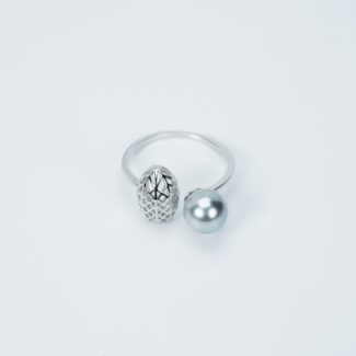 A ring with a simple silver band featuring one textured silver bead and one smooth light blue set against a plain white background.