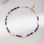 An elegant bracelet featuring a pattern of deep blue rectangular gemstones, natural pearls, and small gold-tone accents laid out on a light surface. Elegant pearl jewelry