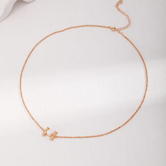 A delicate necklace with a small heart pendant, showcased on a white background, features a fine, linked texture and includes an adjustable clasp enhanced with natural pearl. Elegant pearl jewelry