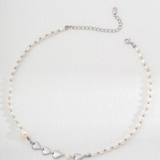 A delicate necklace featuring small white pearls and five heart-shaped silver charms at the center, with an adjustable silver chain and clasp. The o_1hv8s3jhq13dh1h6qmiv4n717bl0 is displayed against a white background. Elegant pearl jewelry